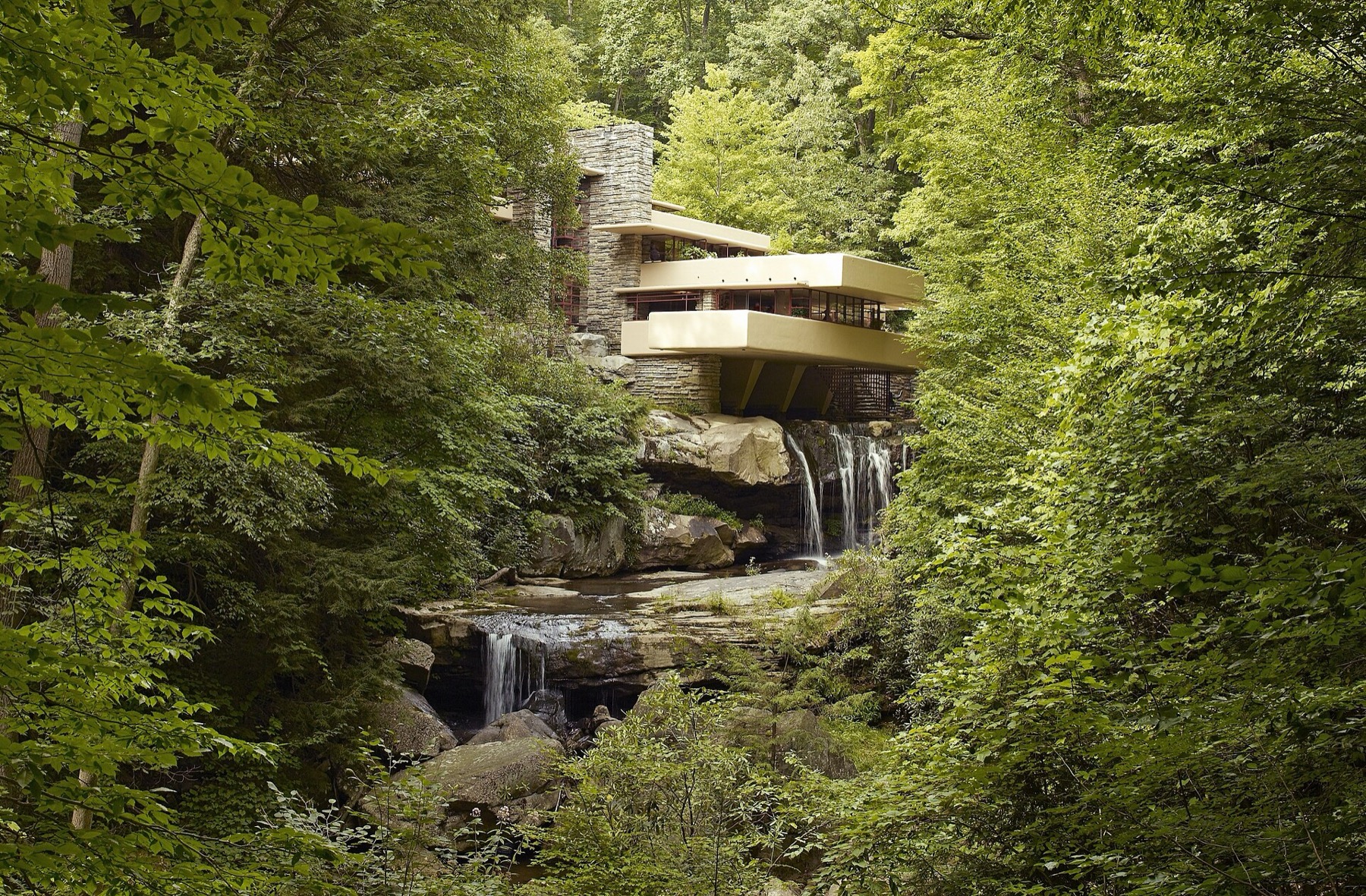 Frank Lloyd Wright’s Fallingwater cantilevered over a woodland waterfall