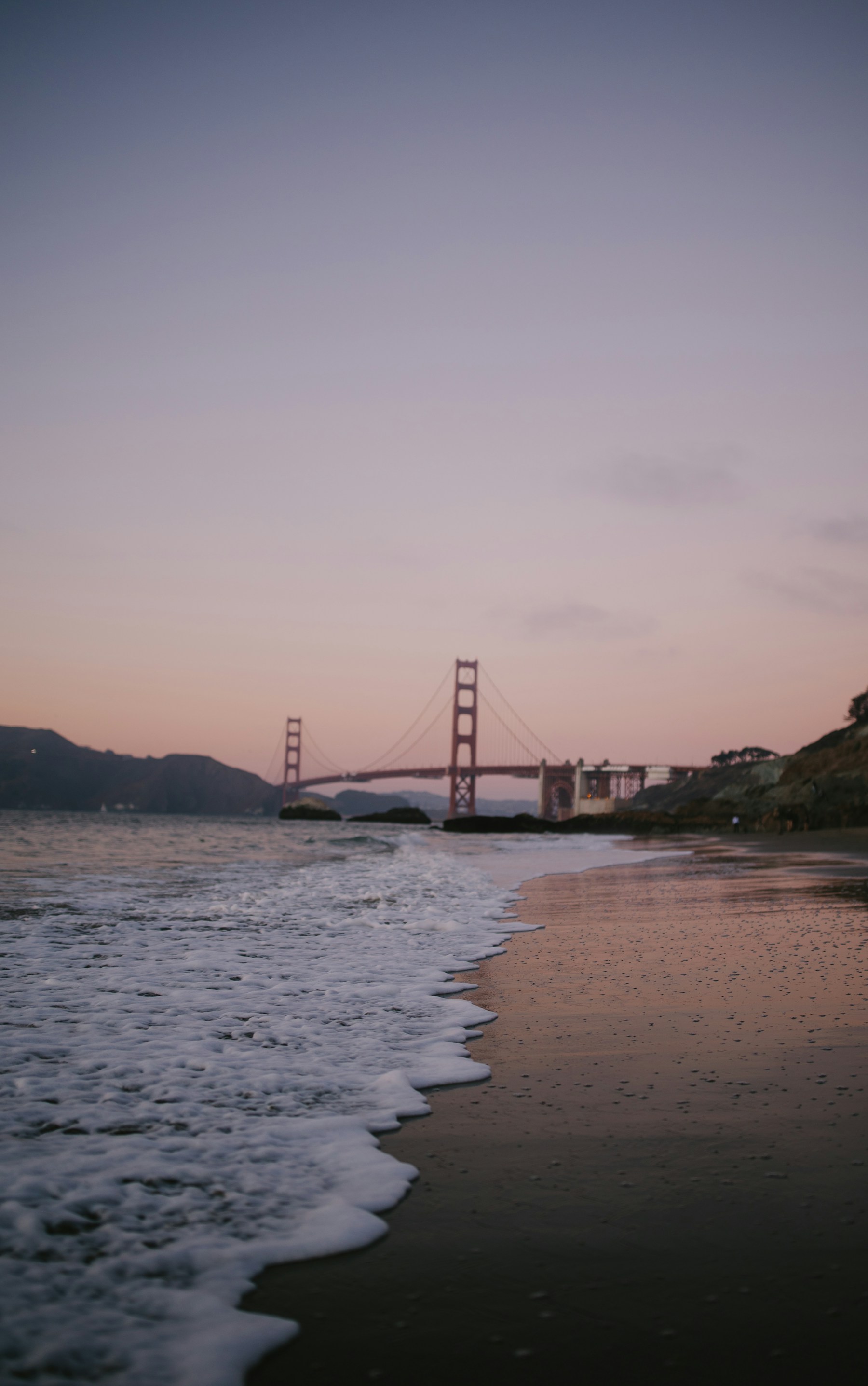 The Golden Gate Bridge disappearing into coastal mist