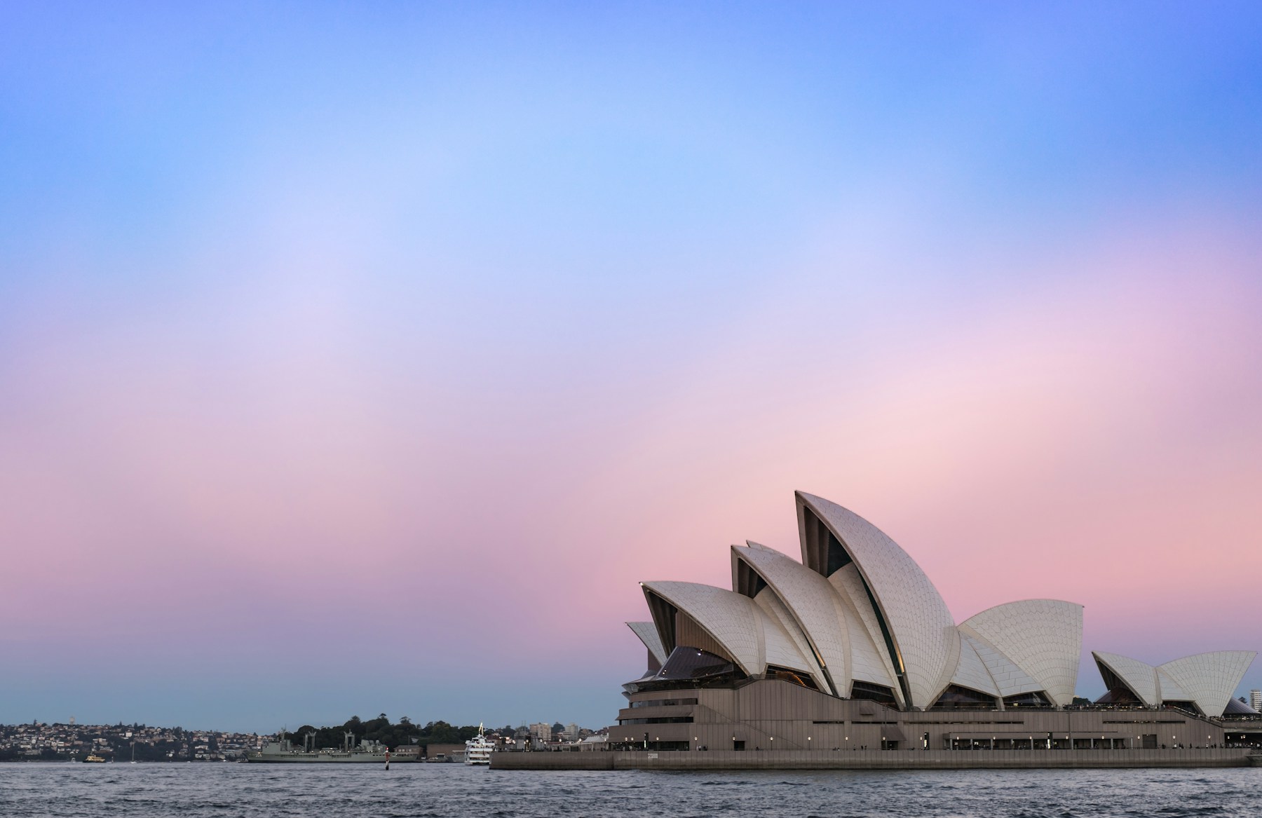 The white tiled sails of the Sydney Opera House at dusk